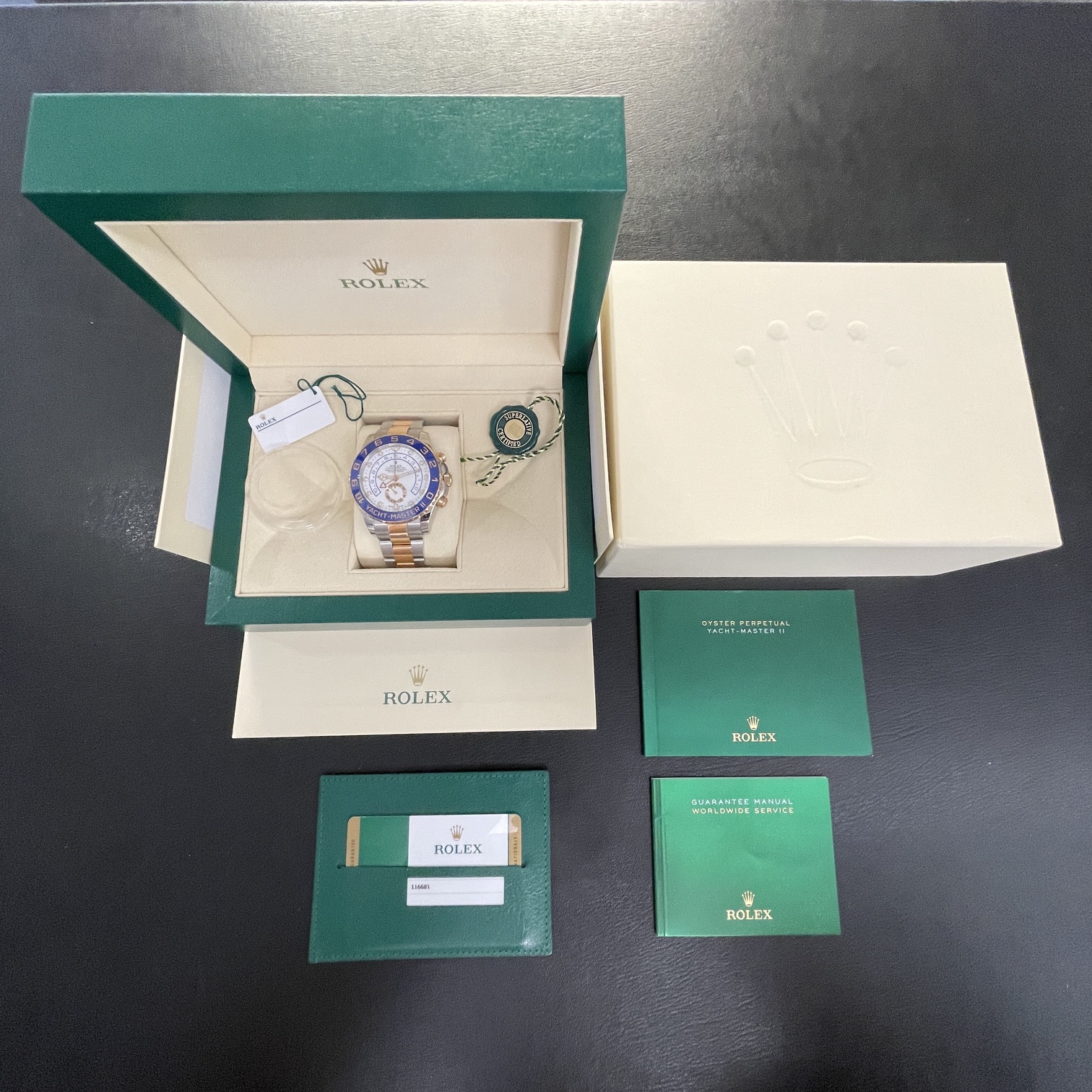 Original manufacturer's box with original papers and warranty card for a pre-owned luxury watch.